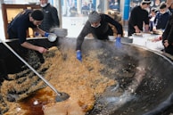 Catering staff preparing food for a large gathering.