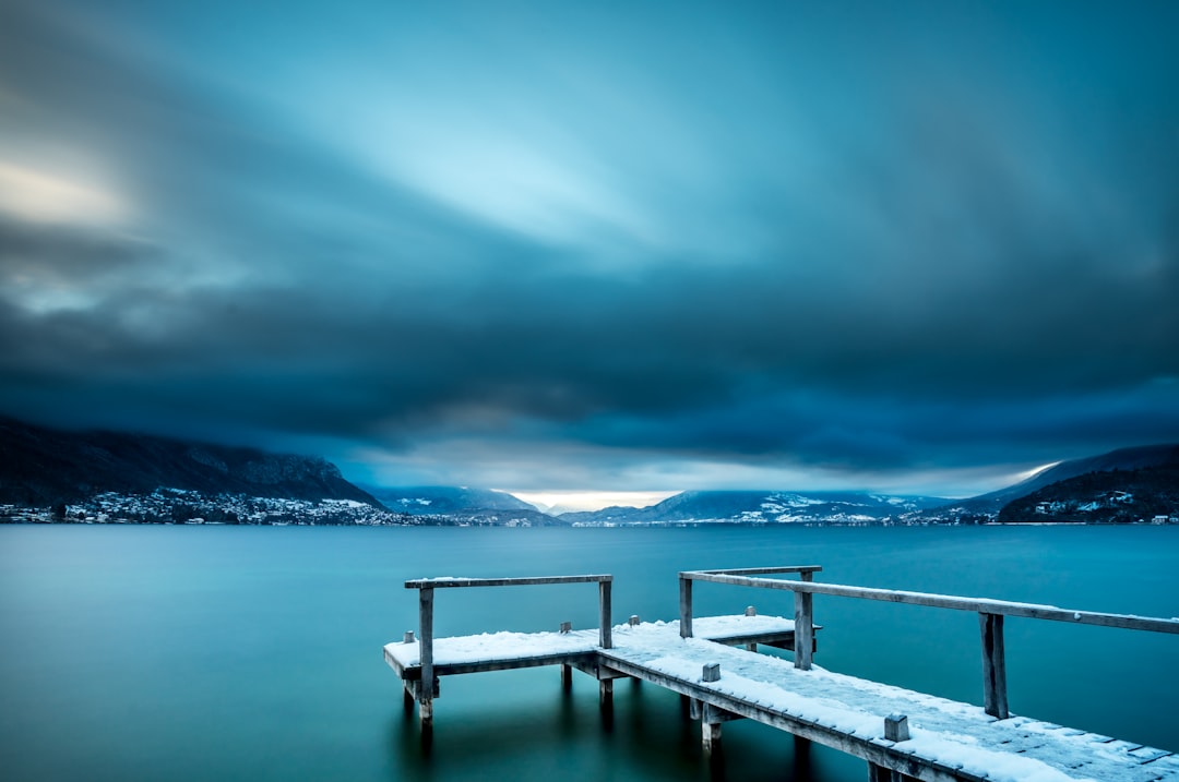 white wooden dock on body of water during daytime