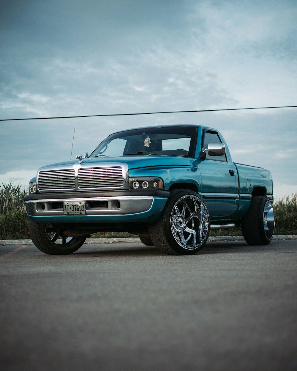 blue chevrolet crew cab pickup truck on road during daytime