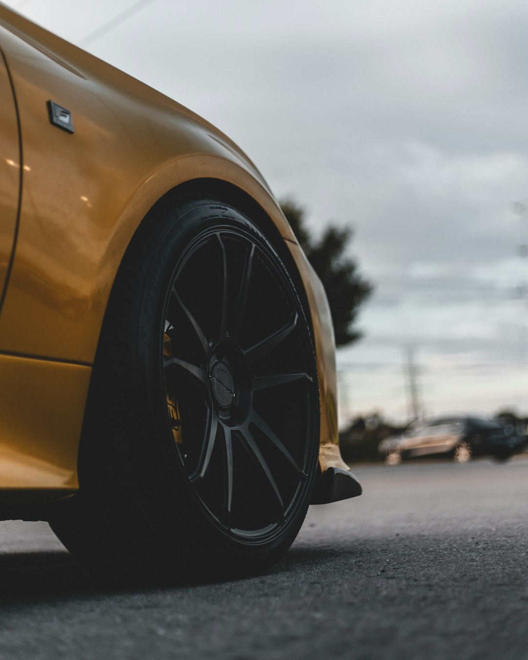 yellow car on gray asphalt road during daytime