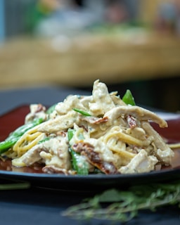 A close-up of a steaming dish of homemade pasta with fresh ingredients.
