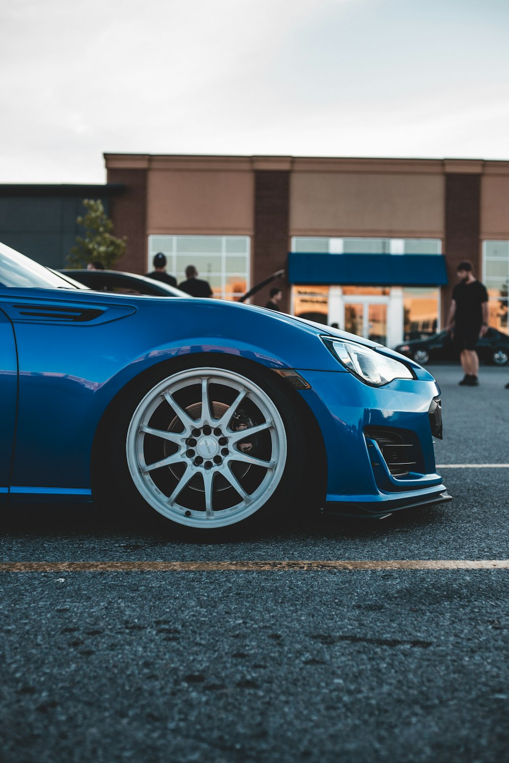 blue ferrari 458 italia parked on gray concrete road during daytime