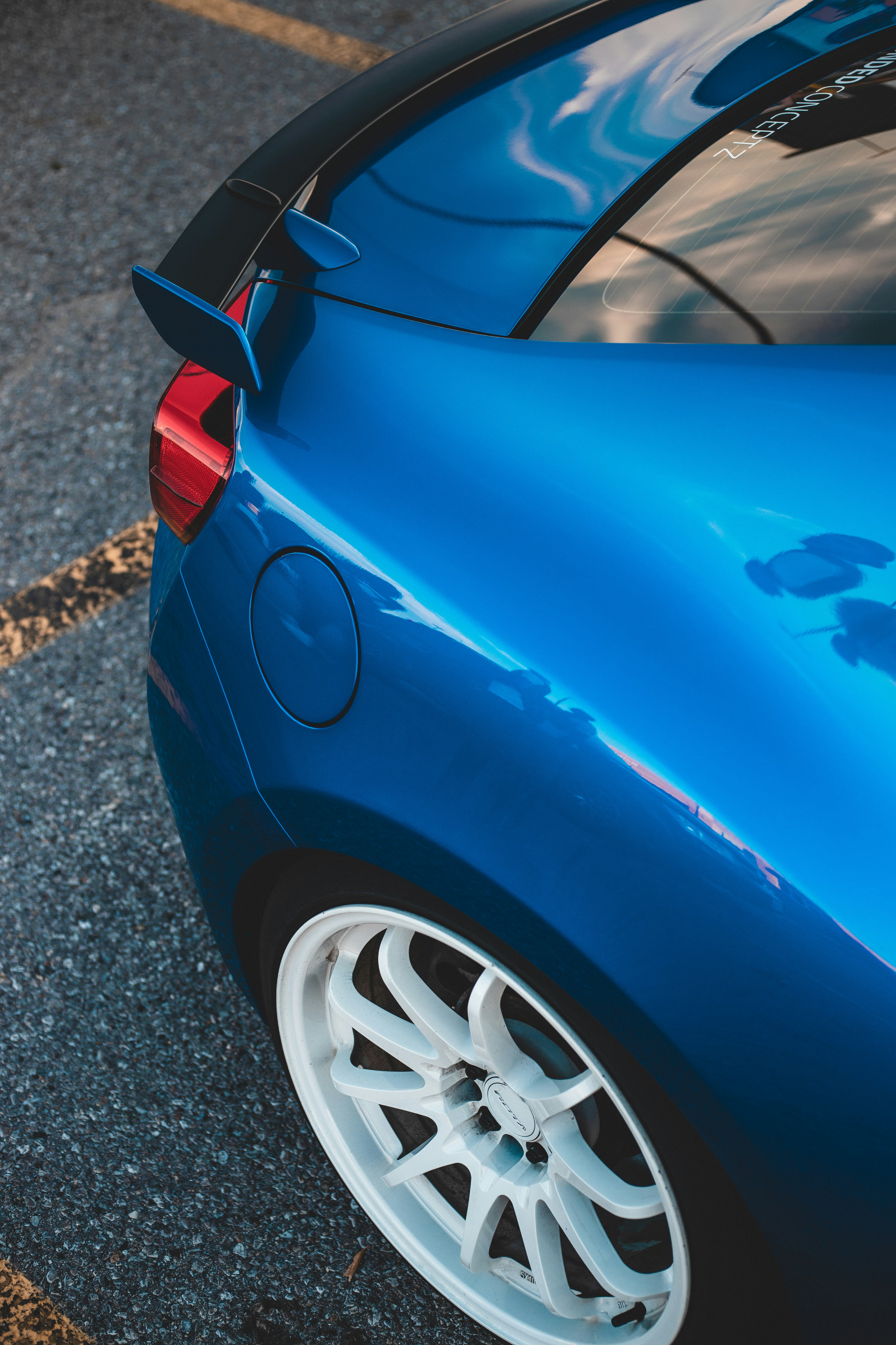 blue car on gray asphalt road during daytime