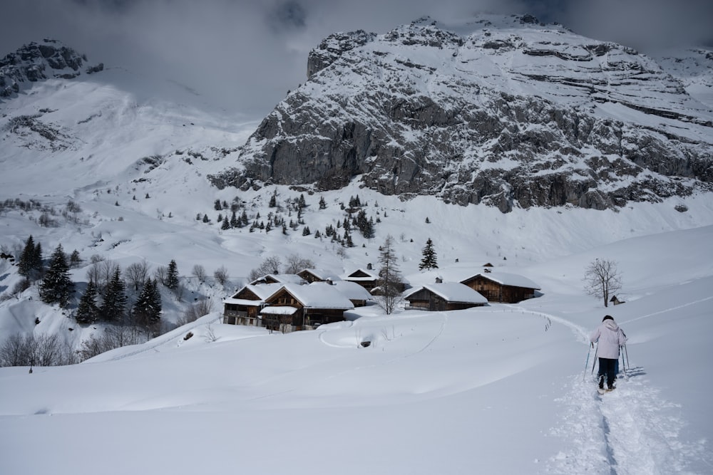 brown wooden house on snow covered mountain during daytime