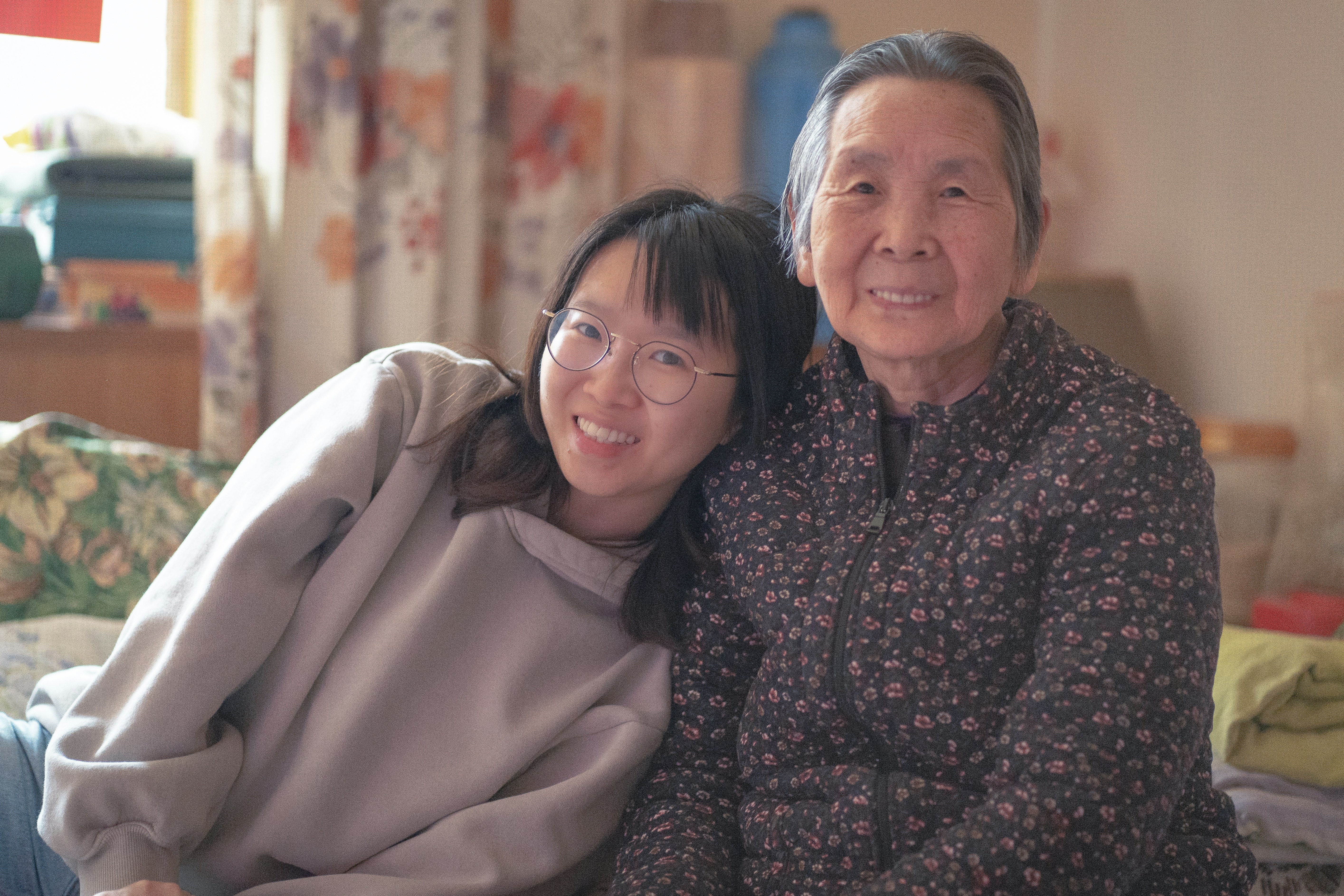 woman in black and red floral long sleeve shirt beside woman in white hijab