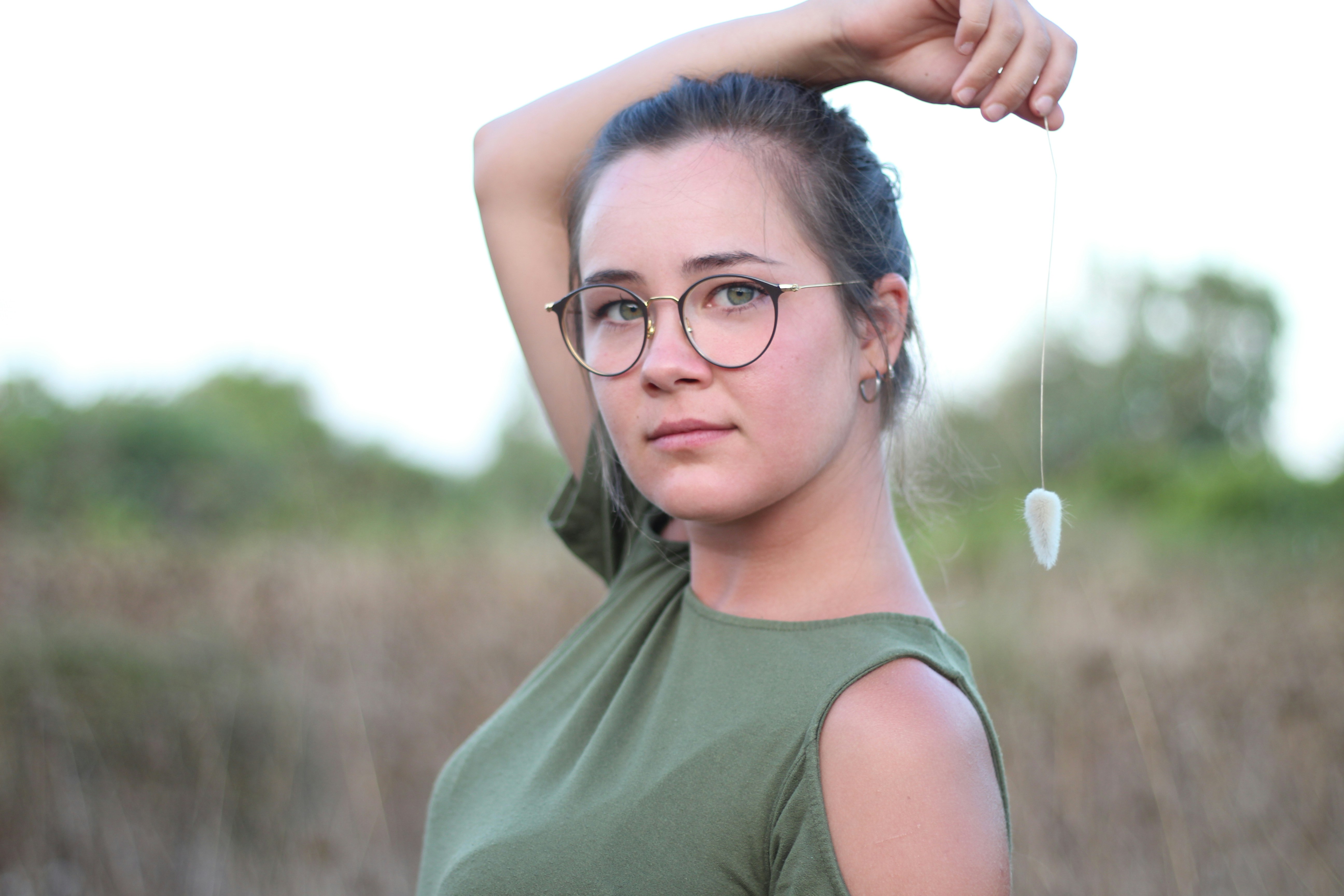 woman in gray tank top wearing black framed eyeglasses