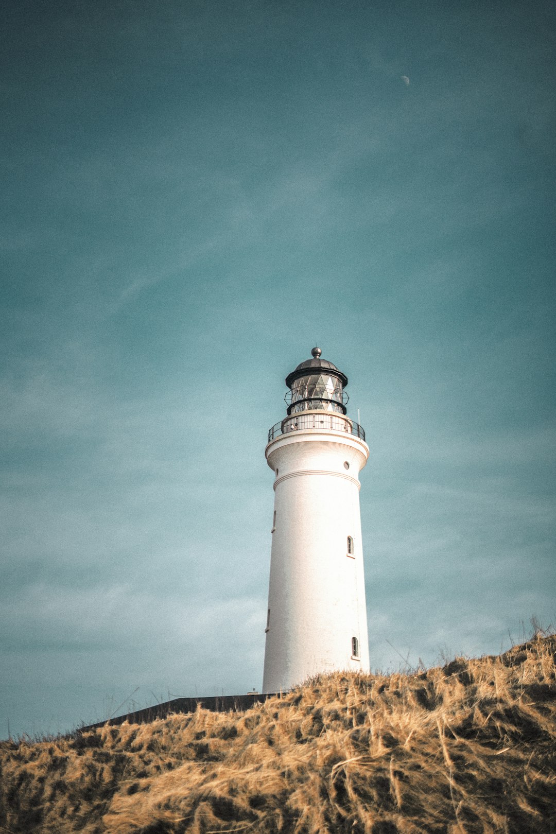 white light house under blue sky