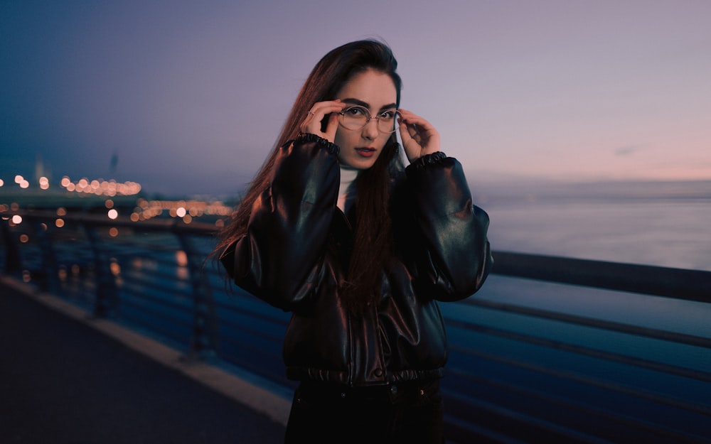 woman in black leather jacket wearing black framed eyeglasses