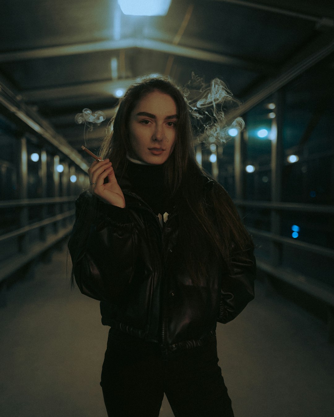 woman in black leather jacket standing on train station