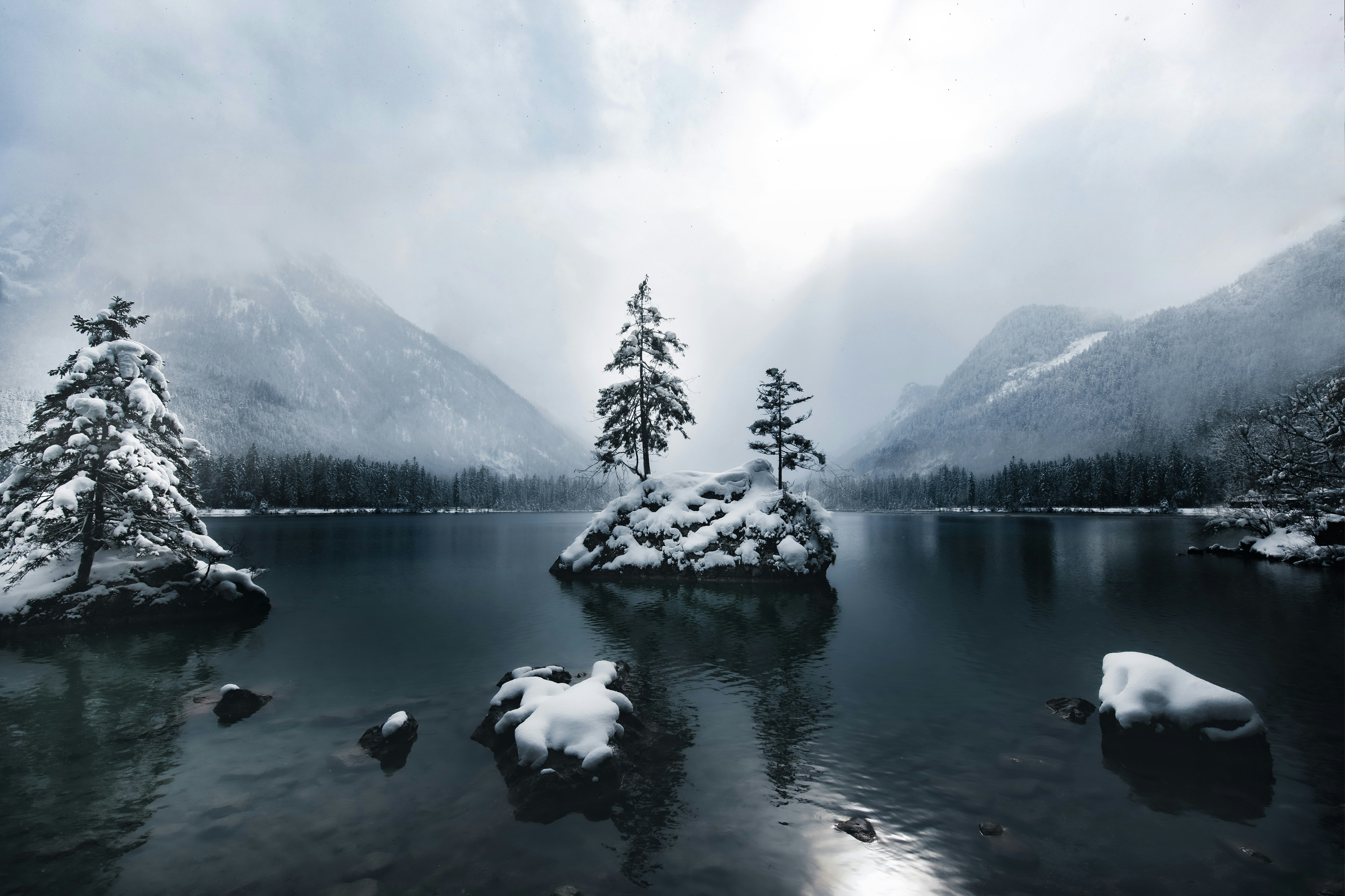 lake near snow covered mountain during daytime