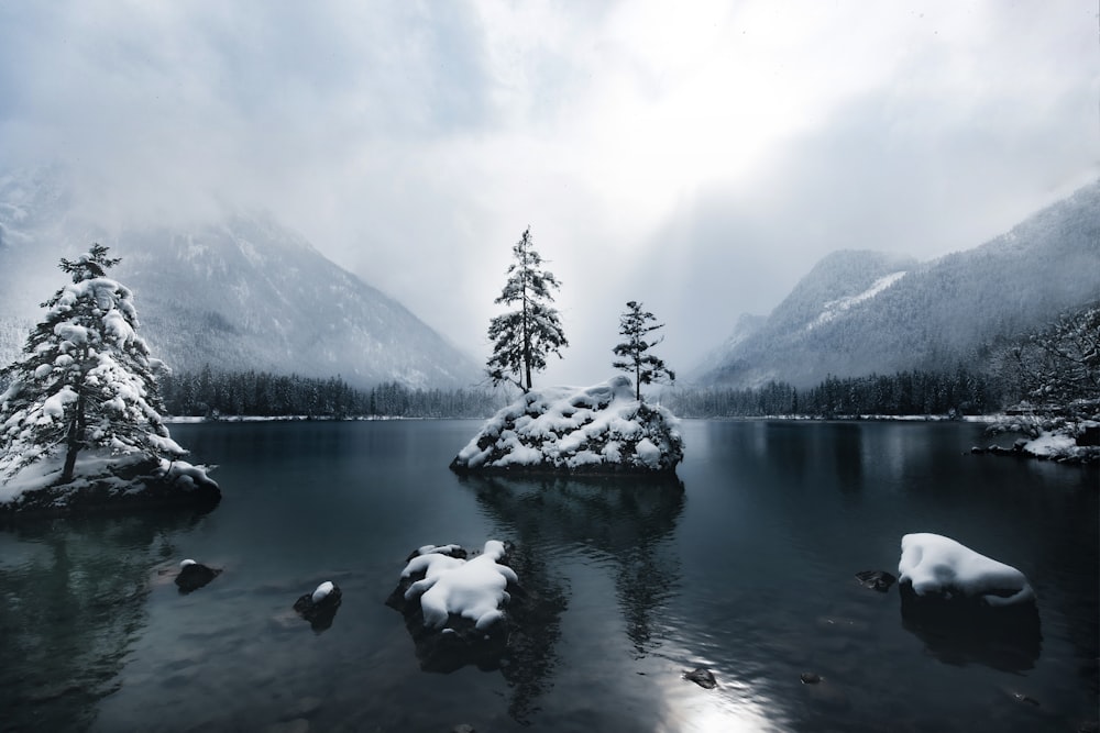 lake near snow covered mountain during daytime