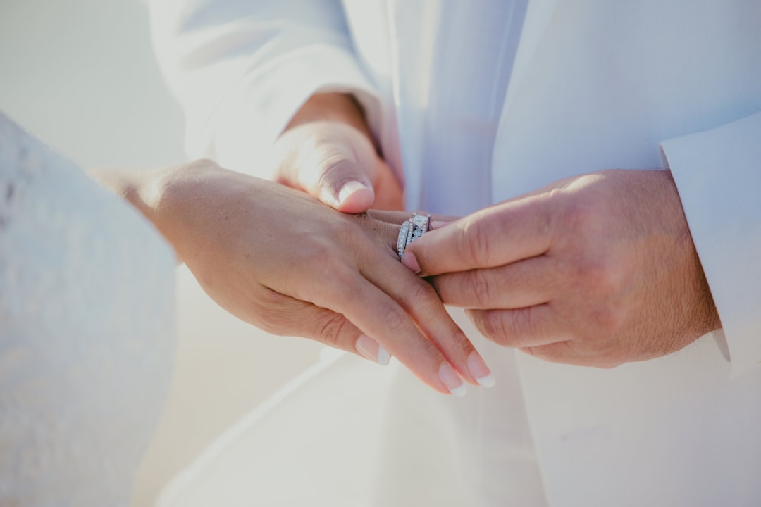 person wearing silver diamond ring