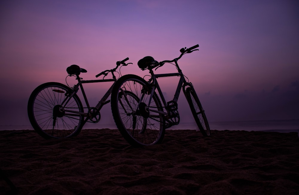 black commuter bike on brown sand during daytime