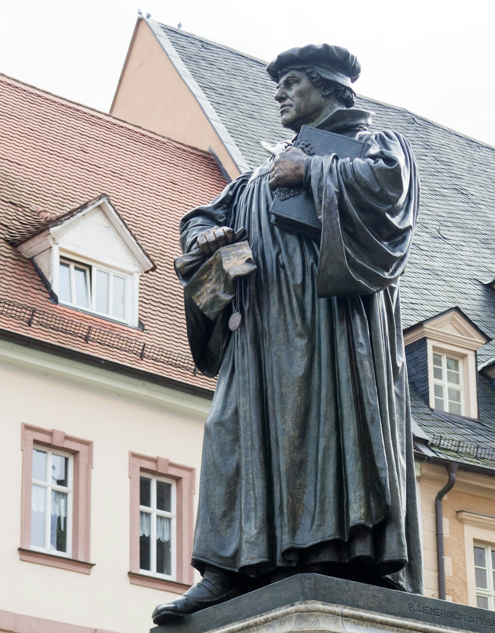man in black coat statue