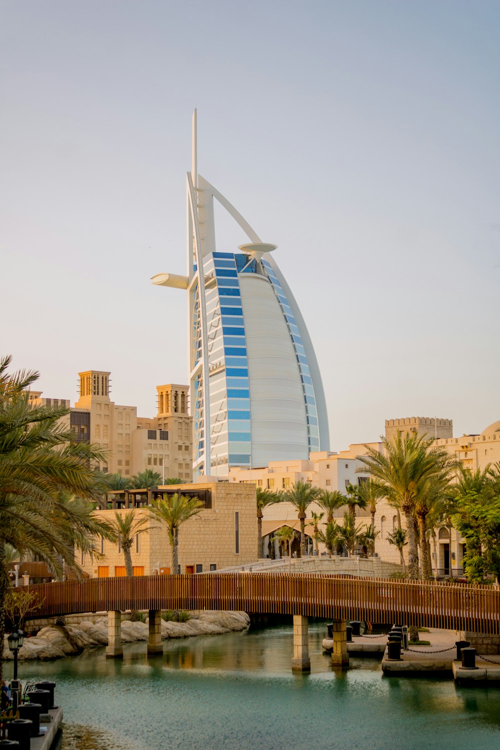 white and blue glass building near green palm trees during daytime