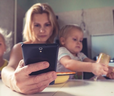 woman in white shirt holding black ipad