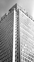 Black and white photo of a modern office building with strong architectural lines.