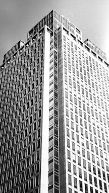 Black and white photo of a modern office building with strong architectural lines.