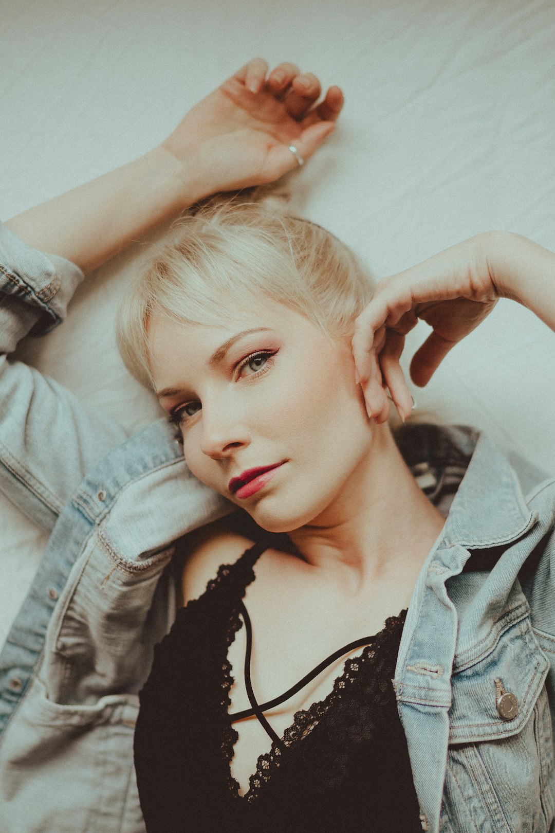 woman in black tank top and blue denim jacket