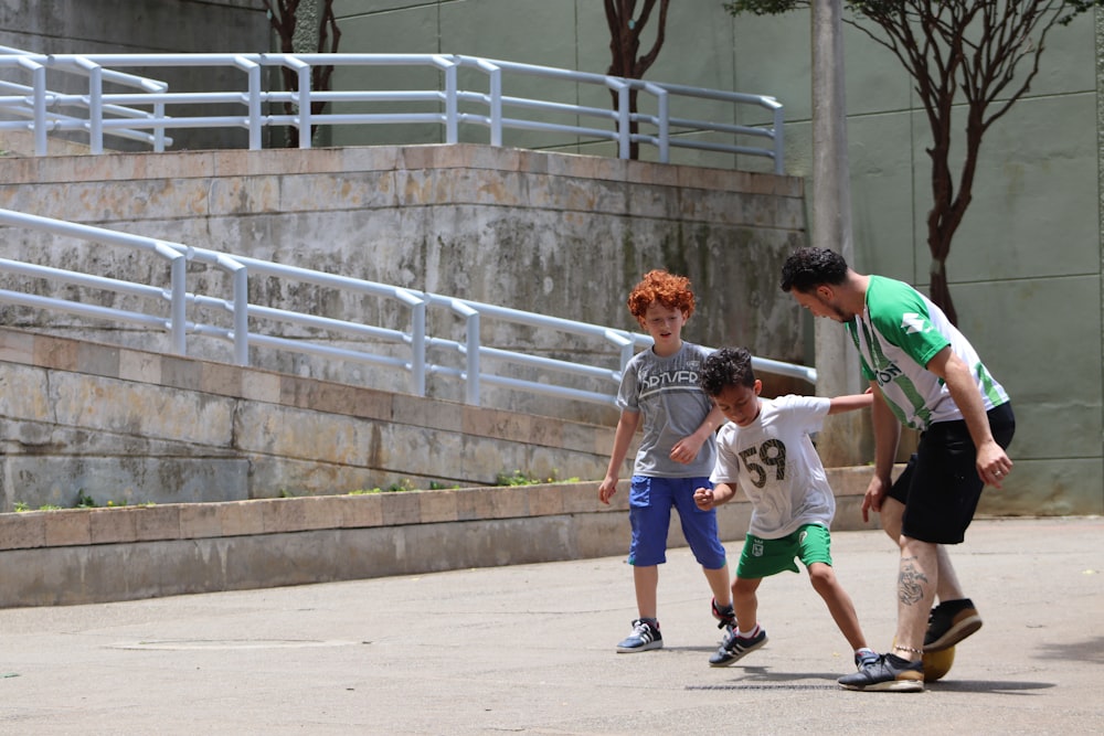 2 boys running on the street during daytime