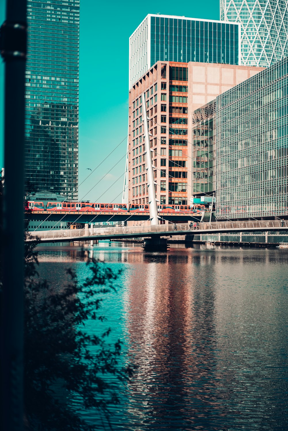 white bridge over river near high rise buildings during daytime