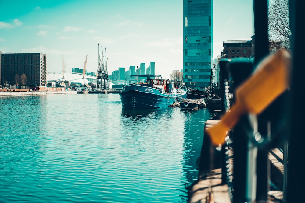 boat on water near city buildings during daytime