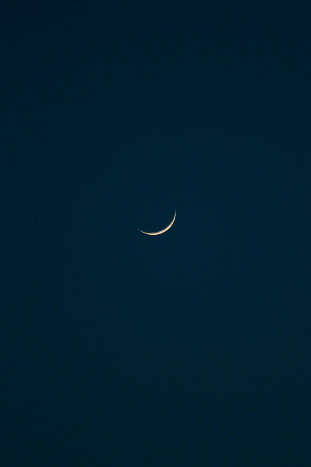 white crescent moon in night sky