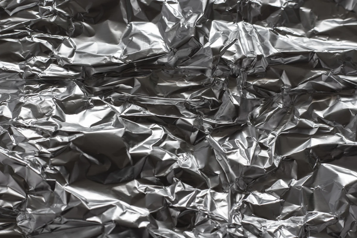 Crinkled silver foil texture resembling shielding material