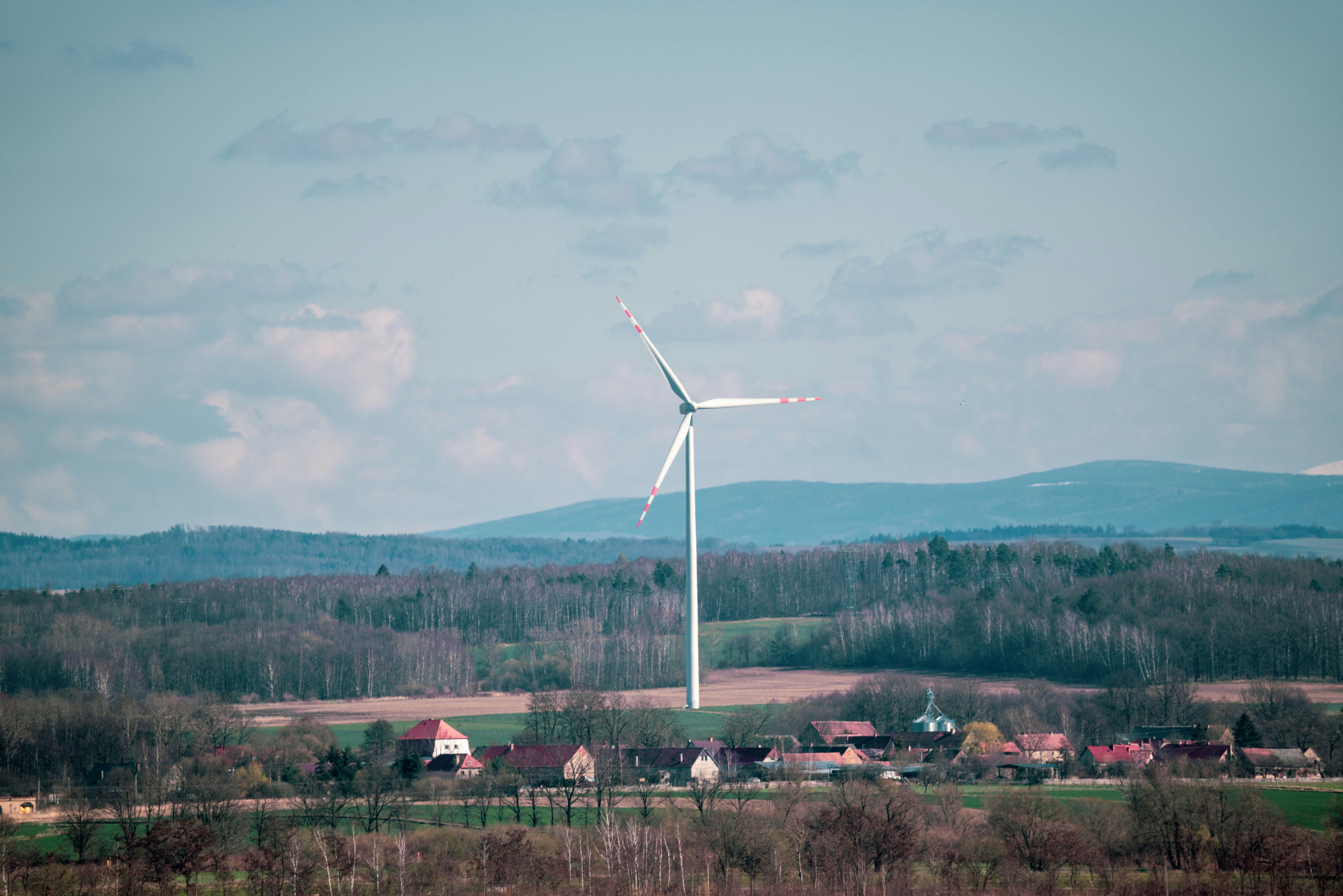 white wind turbine on green grass field during daytime