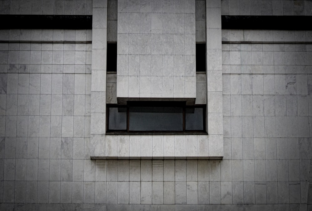 black wooden window on white concrete wall