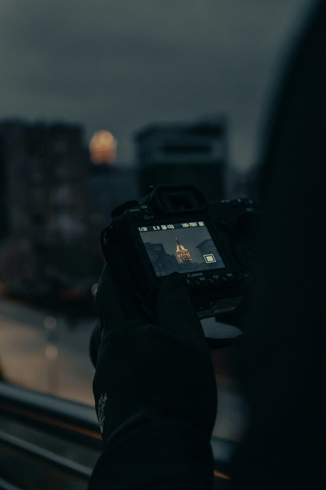 person holding black dslr camera