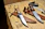 Close-up of durable hunting gear laid out on a wooden table with tools