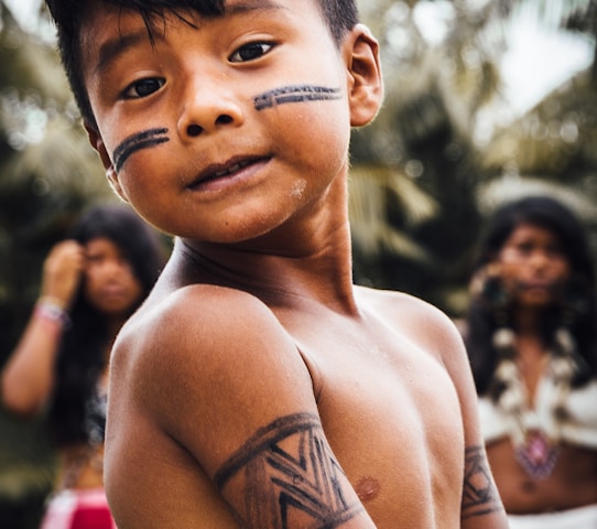 Indigenous boy with tribal black marking.