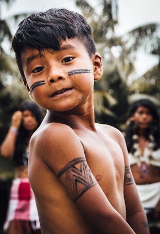 Indigenous boy with tribal black marking.