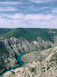 aerial view of lake between mountains during daytime