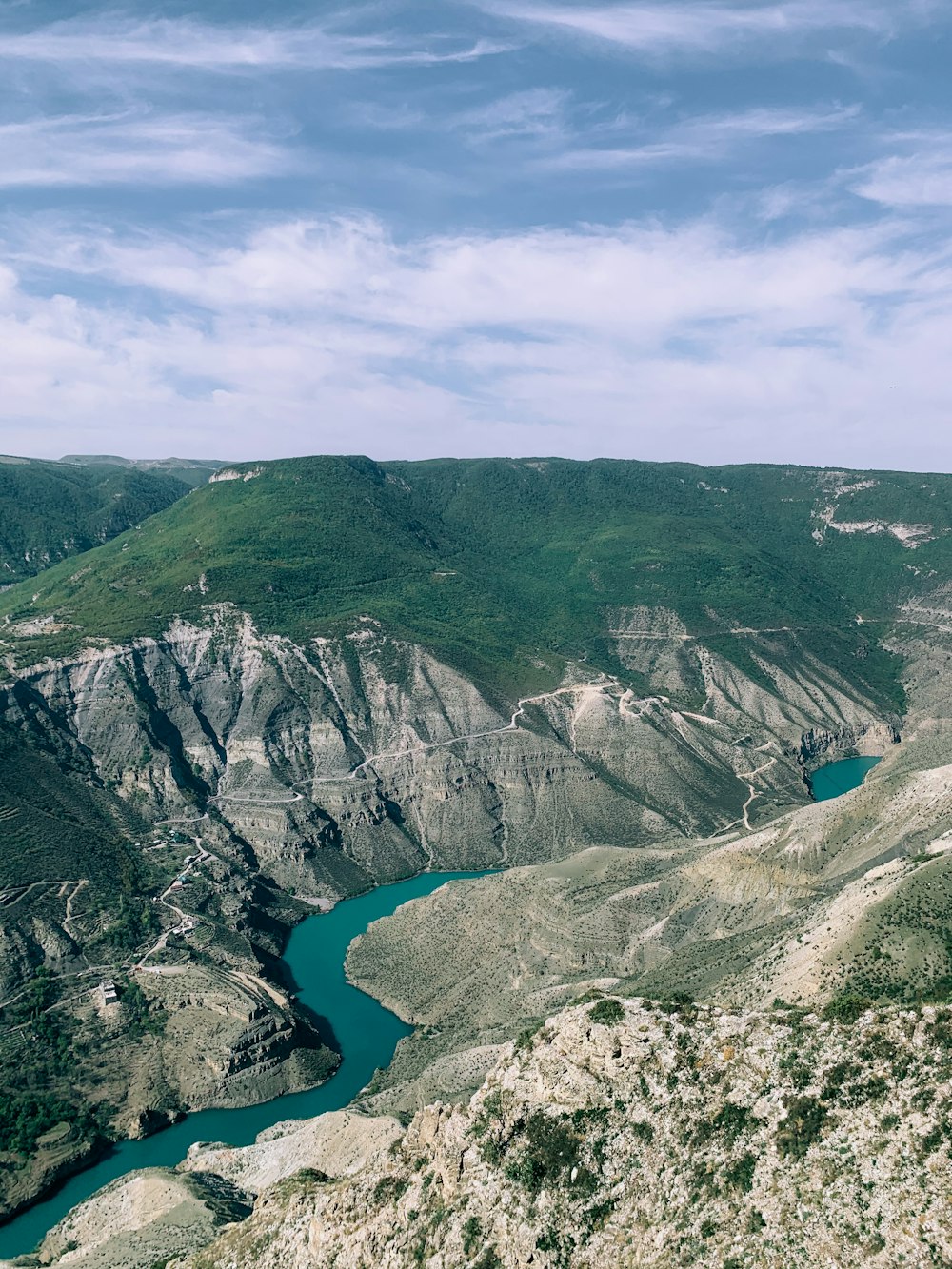 aerial view of lake between mountains during daytime