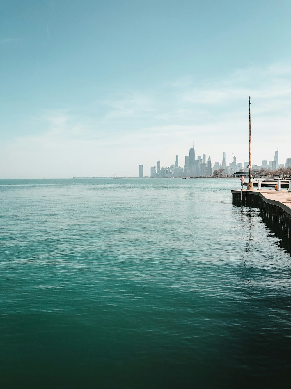 body of water near city buildings during daytime