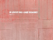 a red wall with a white sticker on it