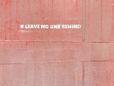 a red wall with a white sticker on it