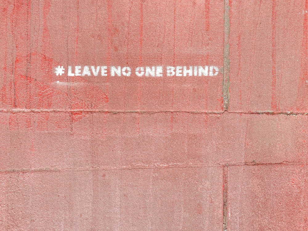 a red wall with a white sticker on it