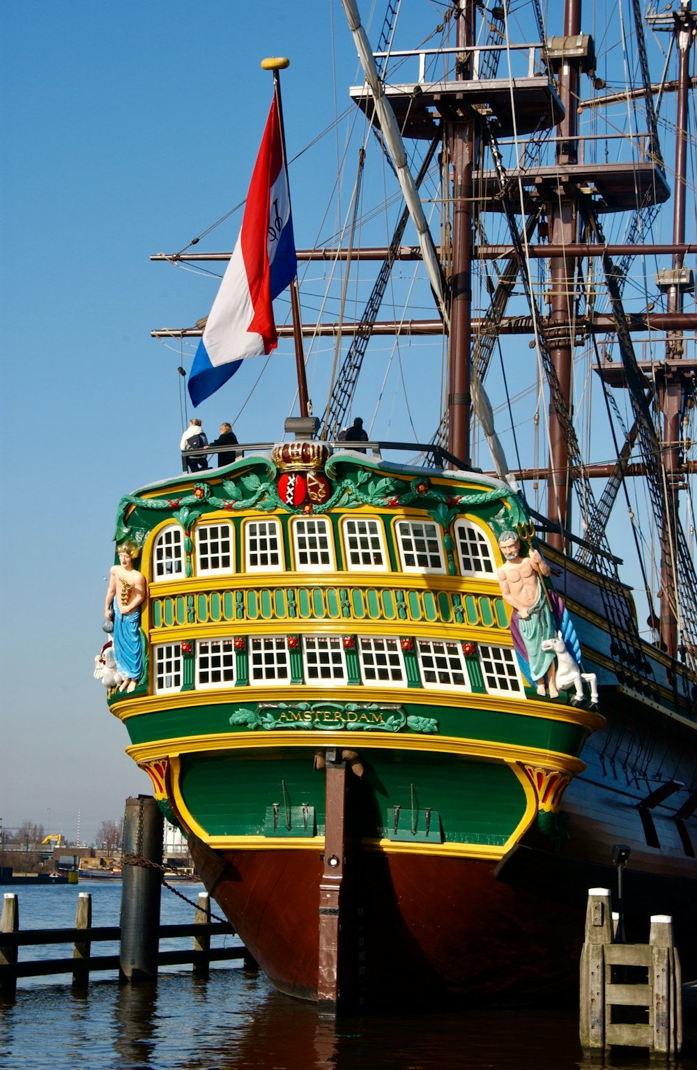 green and brown ship on body of water during daytime