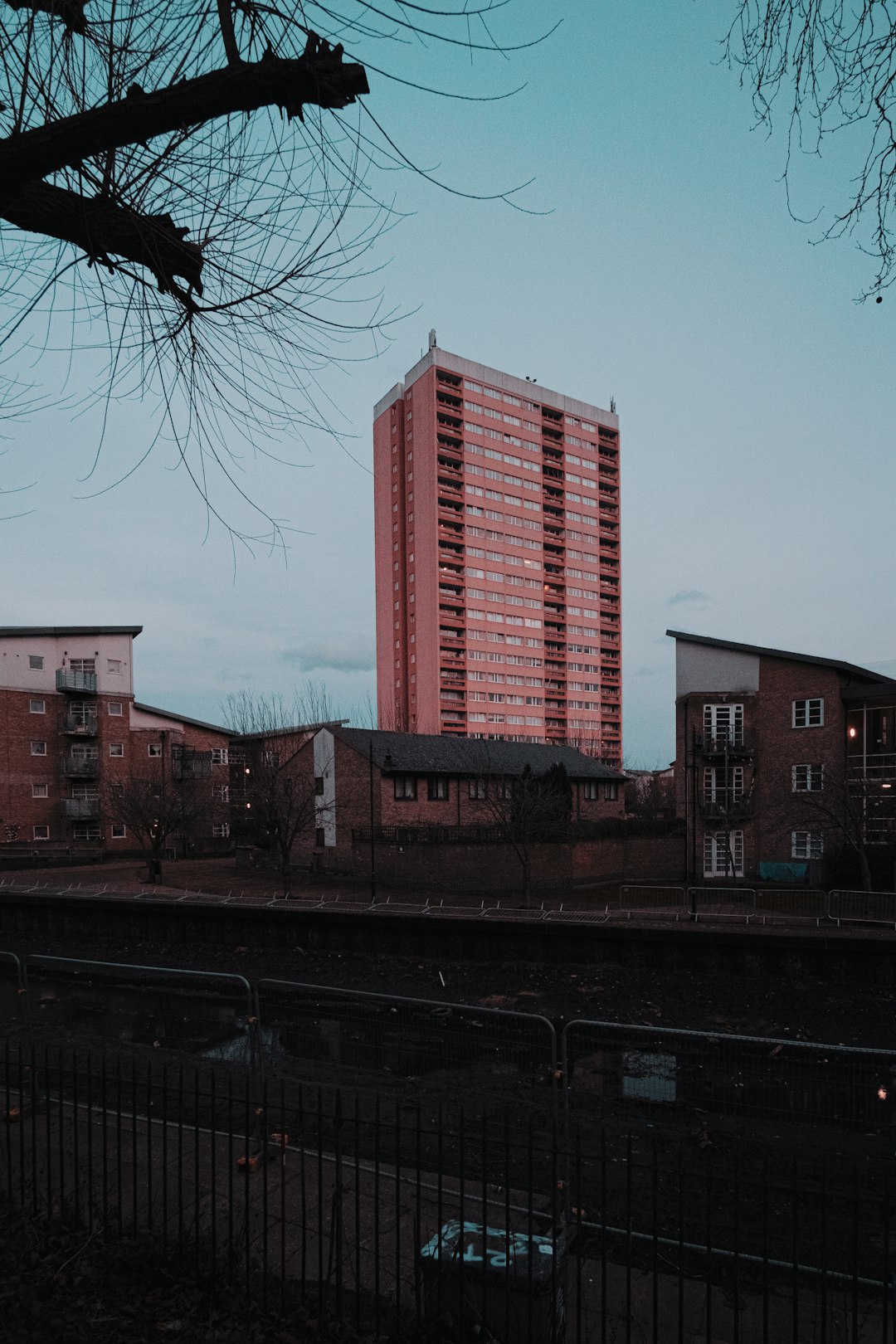 brown concrete building near bare trees during daytime