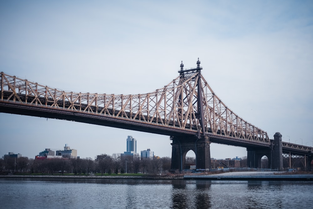 brown bridge over body of water during daytime