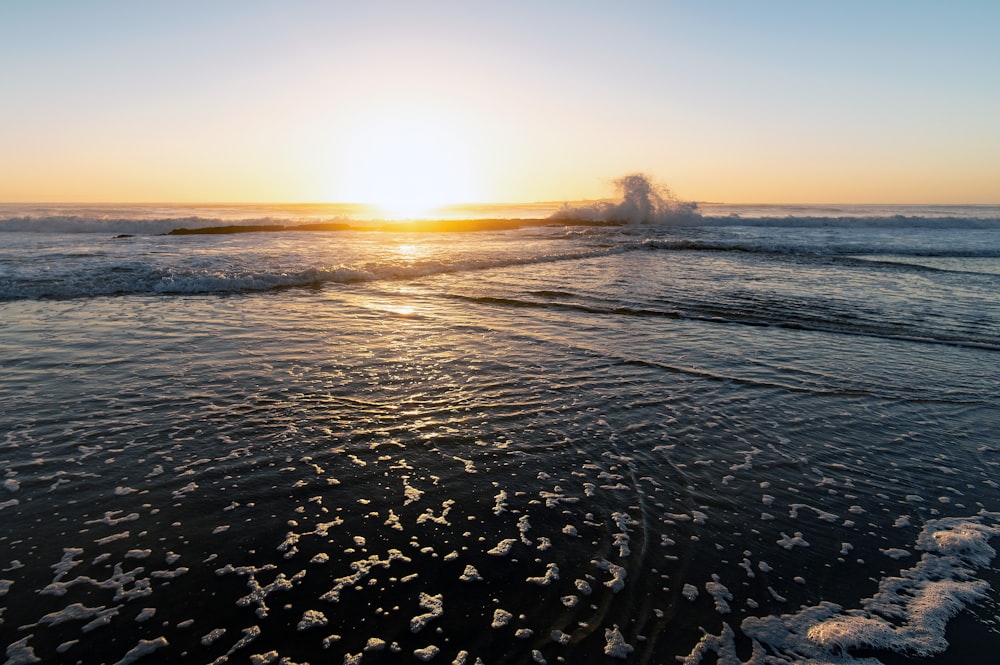 body of water during sunset