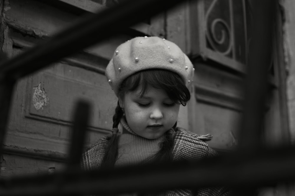 grayscale photo of child wearing hat