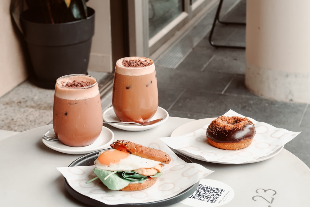 two brown ceramic mugs on white ceramic plate