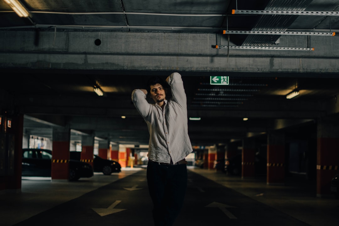 woman in white hoodie and black pants standing on gray pavement