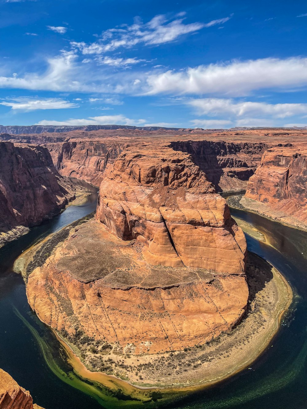 brown rock formation near river during daytime