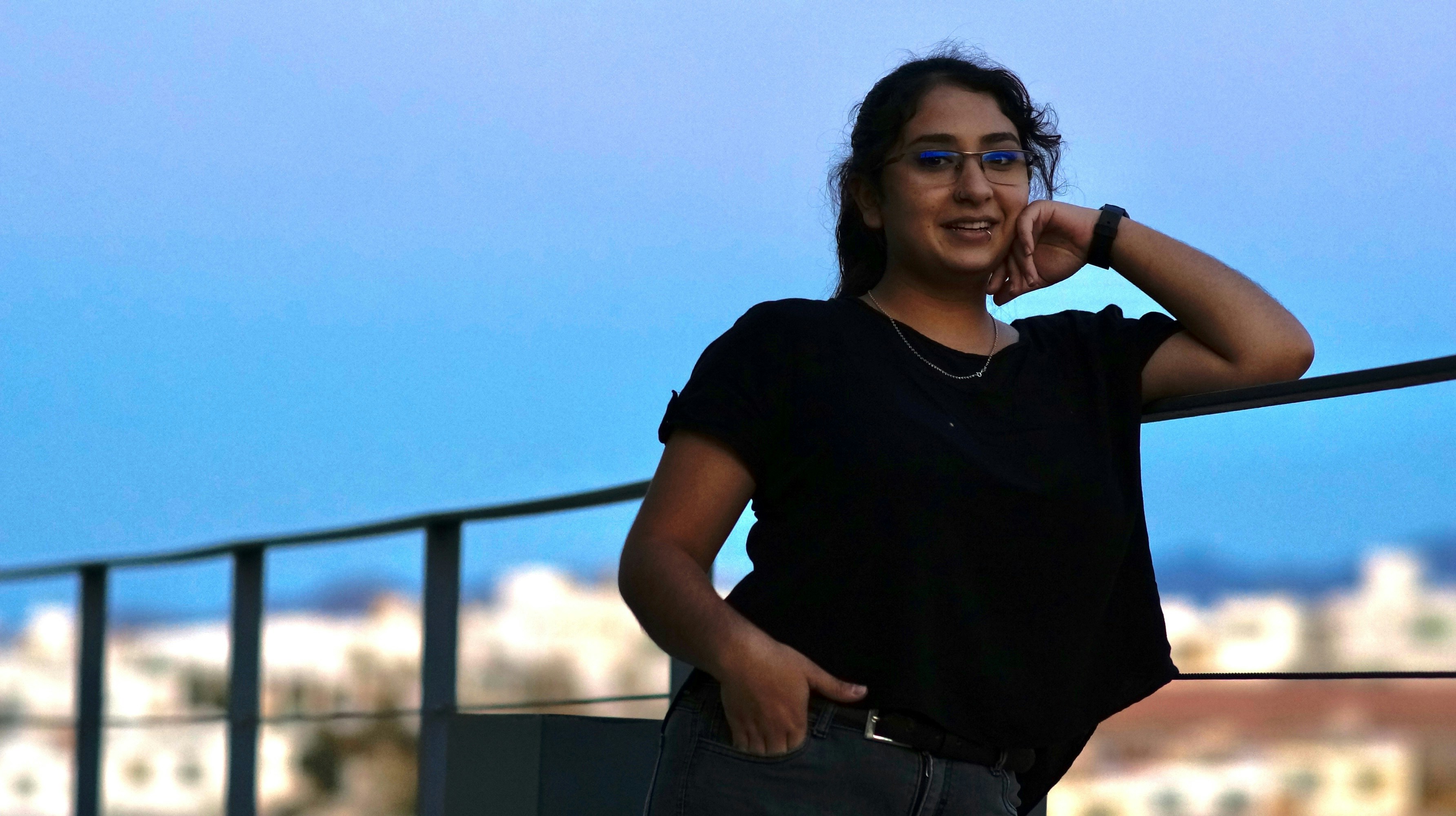 woman in black crew neck t-shirt and blue denim jeans