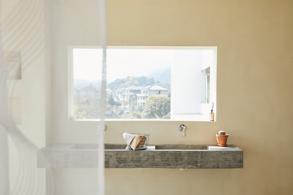 minimalist bathroom concrete sink - stone material - Fall 2023 decor trends